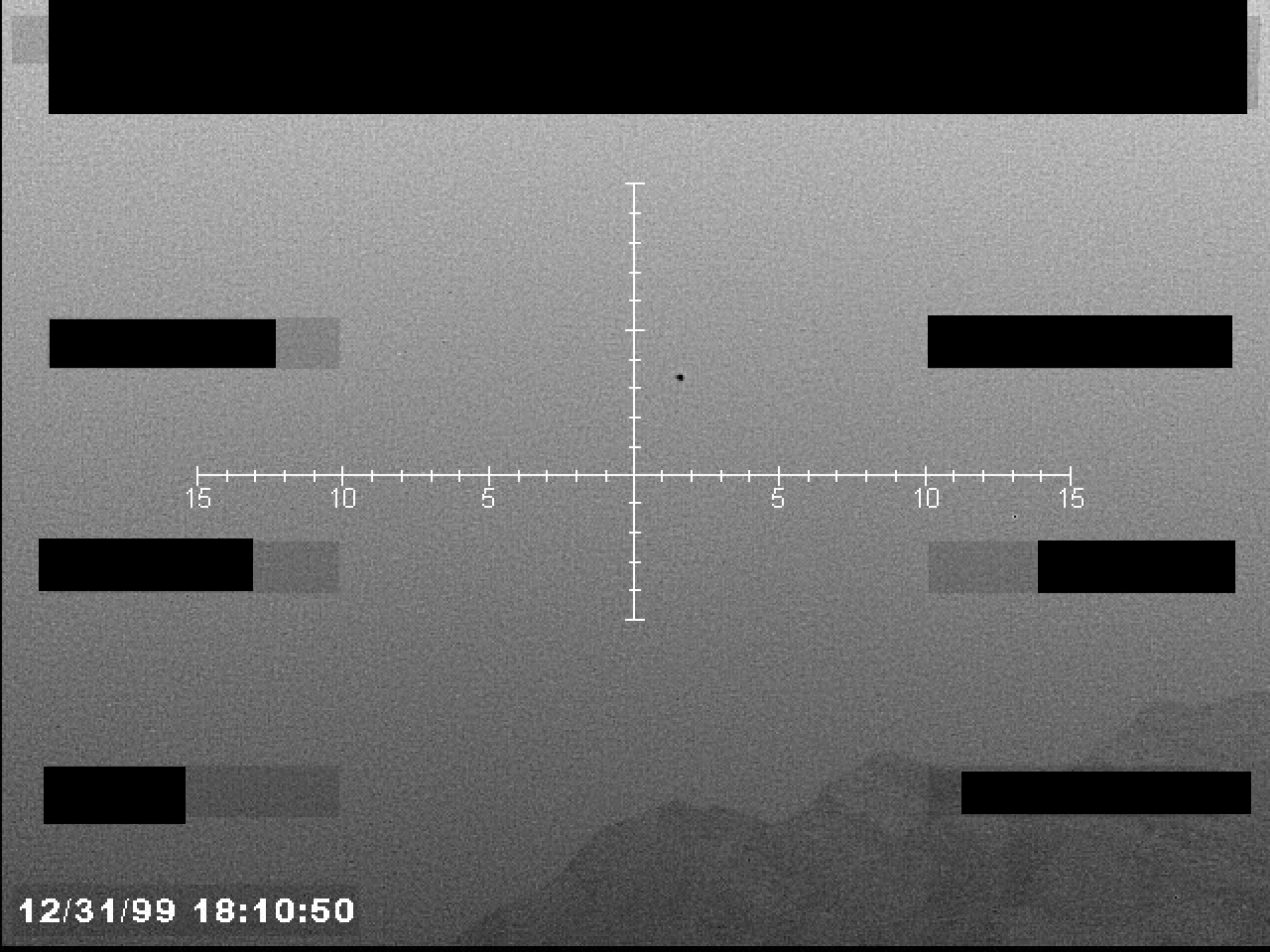 Sensor display view with a central crosshair, numerical markings on the horizontal axis, and a timestamp. A small dark object is visible near the center.