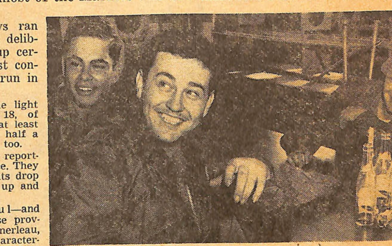 Photo of three men, one smiling prominently in the center.