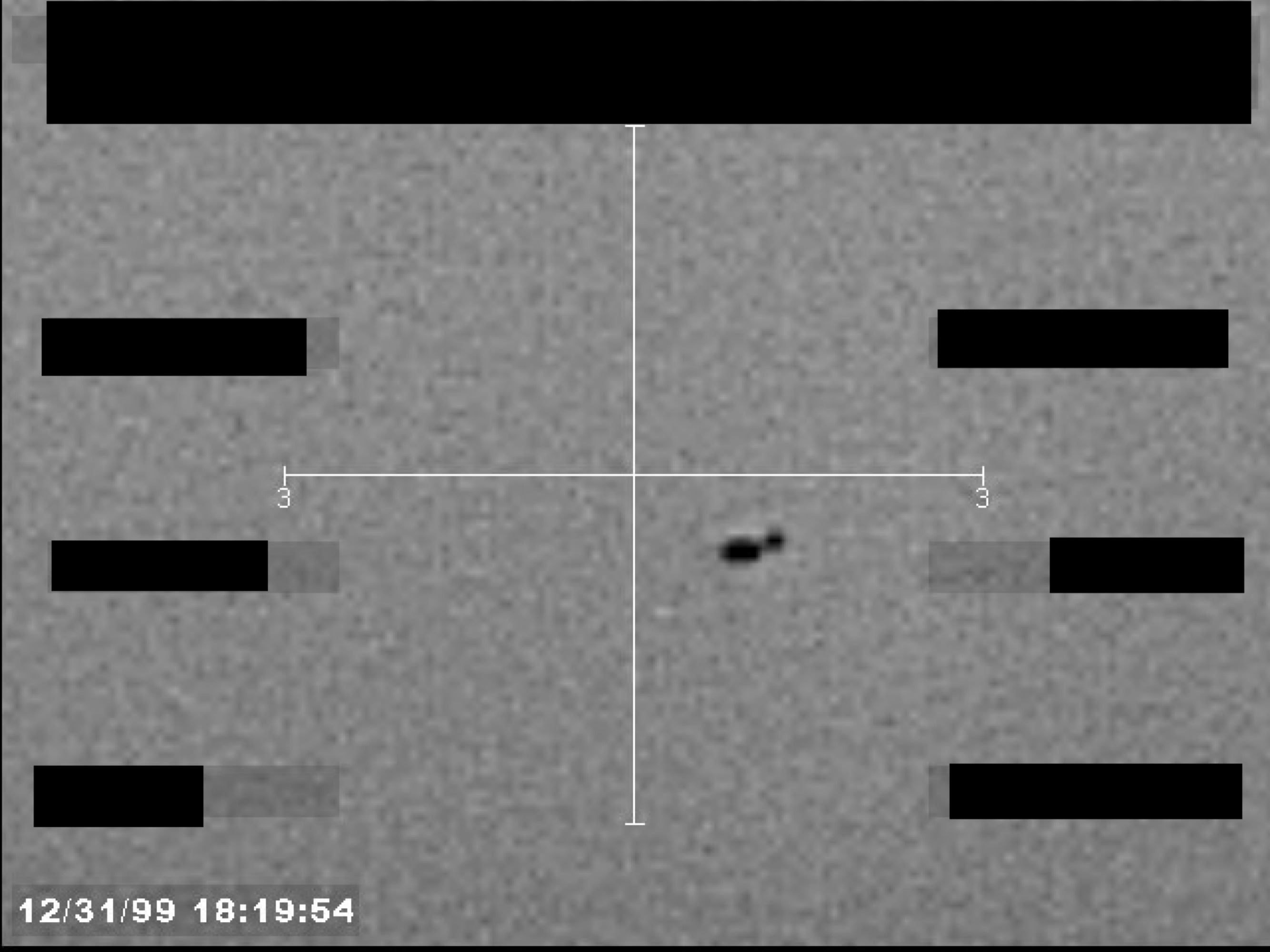 Sensor footage showing a small, dark, unidentified object near a central crosshair, with a timestamp of 12/31/99 18:19:54.