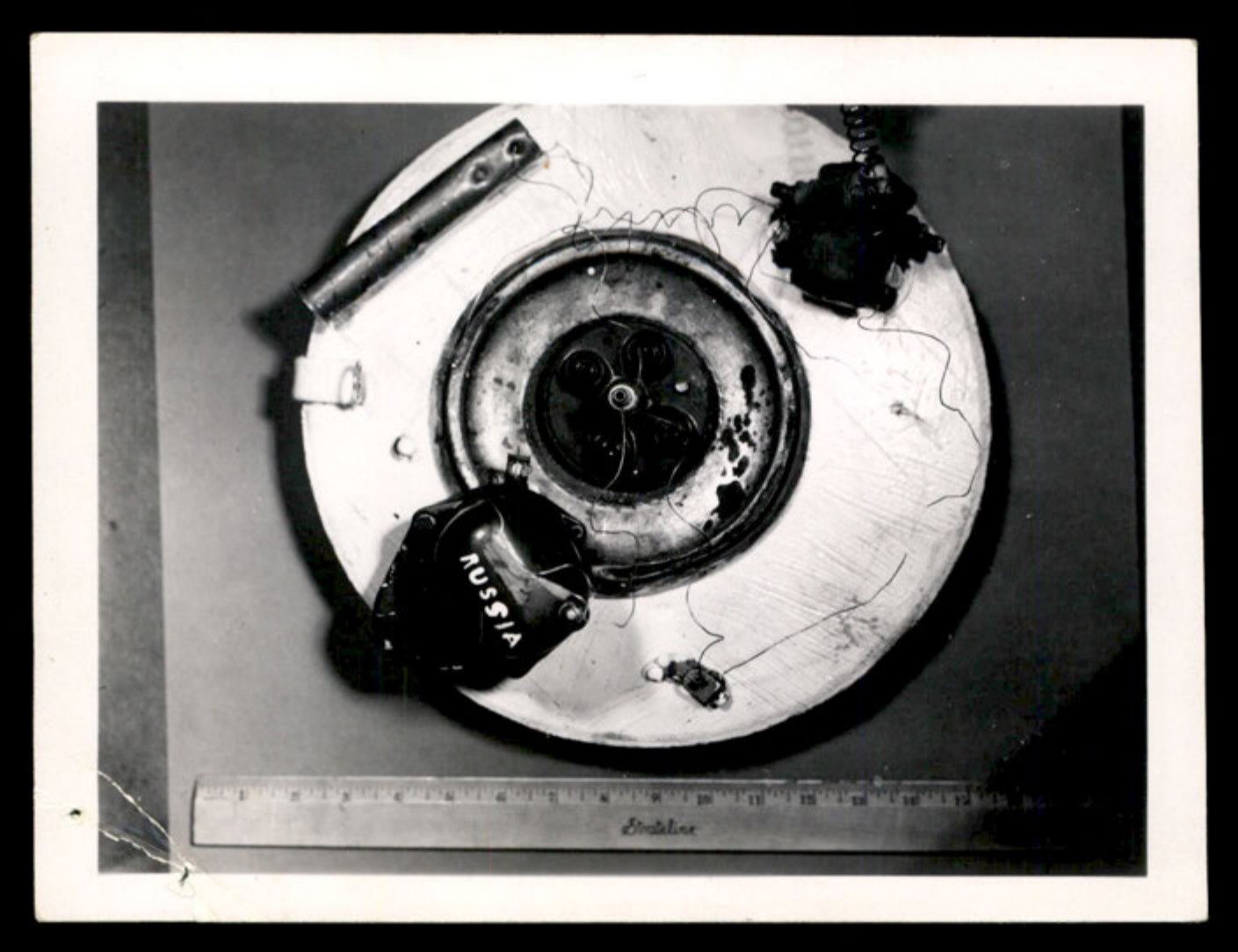 Overhead view of the disc-shaped object with a ruler for scale.