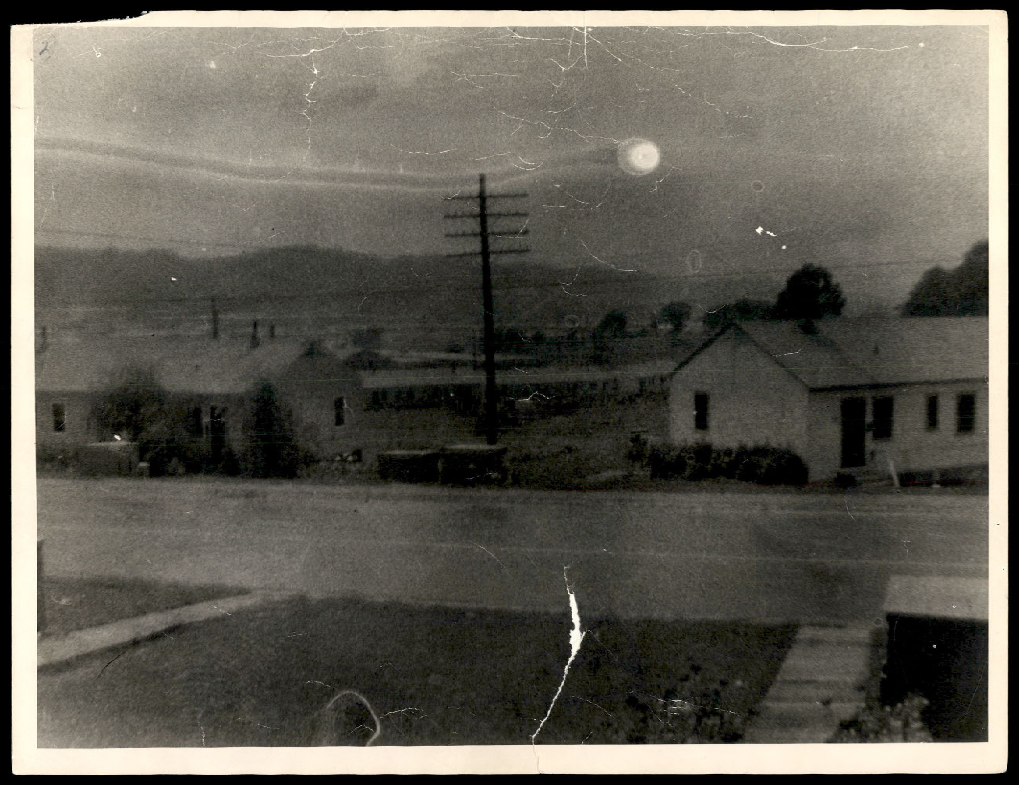 Photograph of the same scene as the previous photo, but with a bright, circular object visible in the sky. This is the 'flying saucer' photograph.
