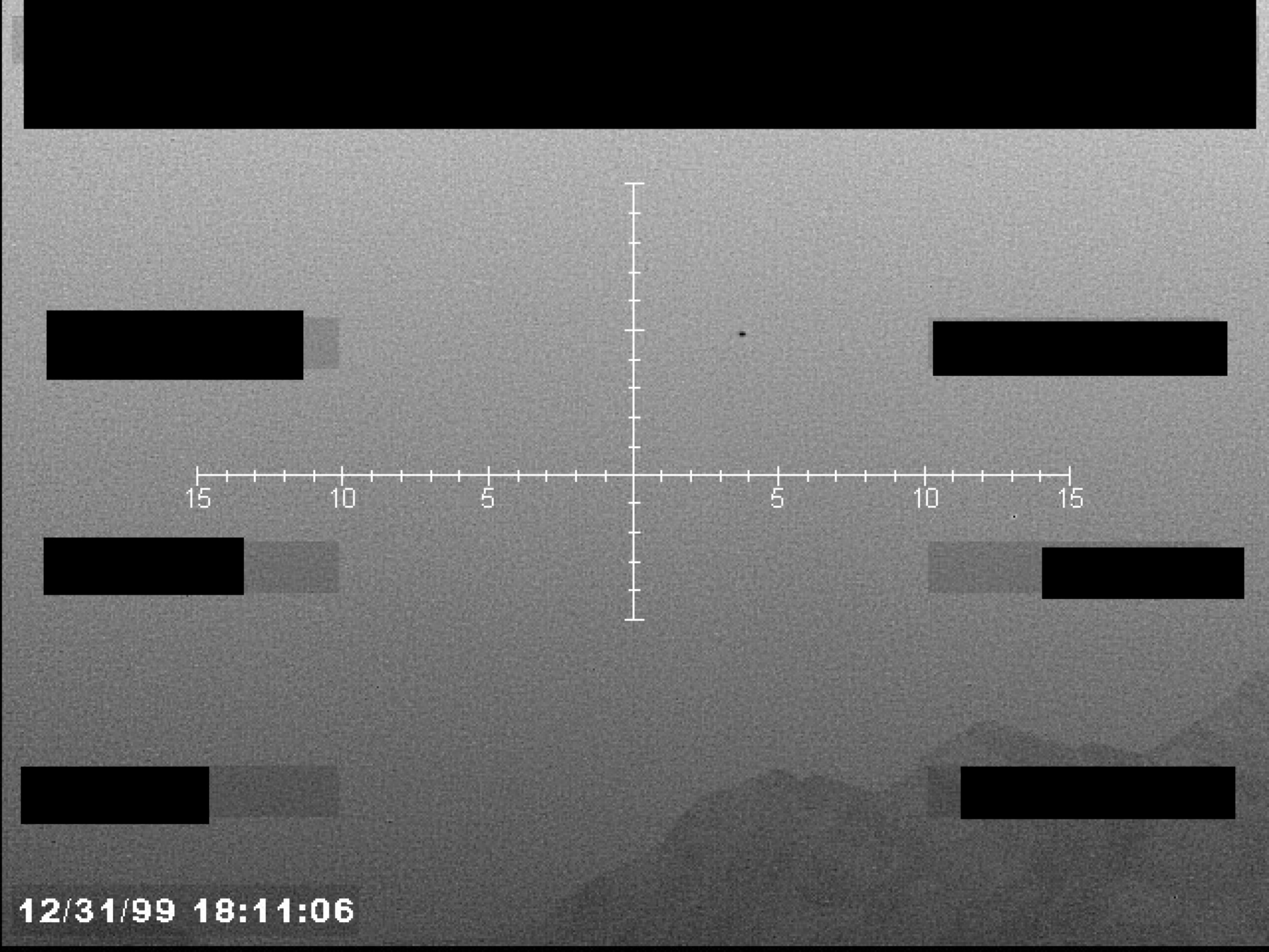 Grayscale sensor image with a central crosshair, numerical markings, and a timestamp in the lower-left corner. Several data blocks are redacted.